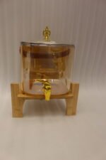6.5L amber shaded glass beverage dispenser with gold spigot on a wooden stand