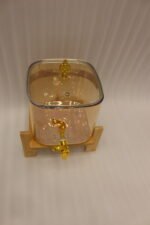 6.5L amber shaded glass beverage dispenser with gold spigot on a wooden stand
