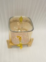 6.5L amber shaded glass beverage dispenser with gold spigot on a wooden stand