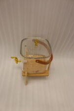 6.5-liter clear glass beverage dispenser with a gold spigot set on a raised wooden stand on a marble countertop
