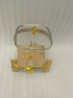 6.5-liter clear glass beverage dispenser with a gold spigot set on a raised wooden stand on a marble countertop