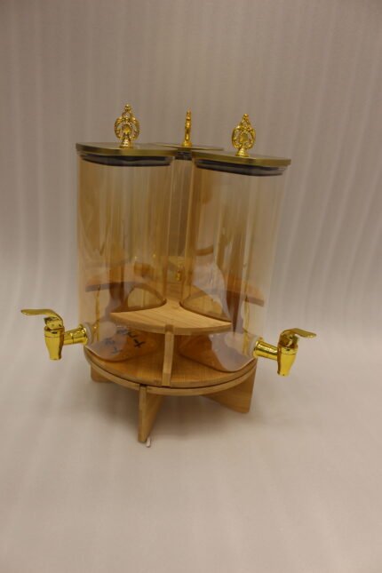 3-piece amber shaded glass beverage dispenser set with gold spigots on a wooden stand