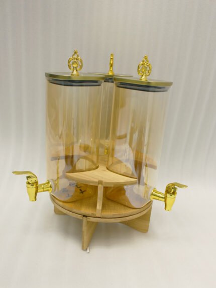 3-piece amber shaded glass beverage dispenser set with gold spigots on a wooden stand
