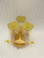3-piece amber shaded glass beverage dispenser set with gold spigots on a wooden stand