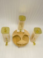3-piece amber shaded glass beverage dispenser set with gold spigots on a wooden stand