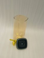 3-piece amber shaded glass beverage dispenser set with gold spigots on a wooden stand
