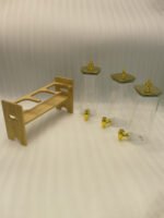 Triple clear acrylic beverage dispenser set on a wooden stand with gold spigots and decorative finial tops on a kitchen counter