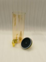 A modern kitchen counter with a three-vessel amber glass beverage dispenser set, held in a bamboo wooden stand. Each 1.8L cylinder has a gold pineapple lid and gold spigot, filled with amber liquid.