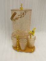 Elegant pink acrylic beverage dispenser with gold swan finial, gold spigot, stand, and 6 matching diamond-cut glasses.