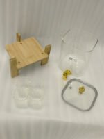 4.2L clear glass beverage dispenser with a gold spigot, gold lid handle, natural wooden stand, and 4 drinking glasses on a kitchen island.