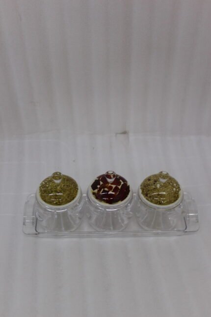 3-piece clear acrylic jar set with patterned dome lids, clear spoons, and serving tray on a kitchen countertop