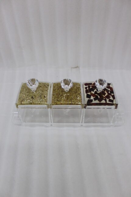 3-piece clear acrylic spice and dry fruit jar set with patterned lids, crystal knobs, and clear tray on marble kitchen counter
