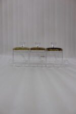 3-piece clear acrylic spice and dry fruit jar set with patterned lids, crystal knobs, and clear tray on marble kitchen counter