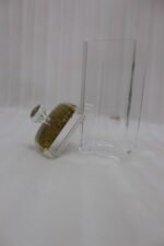 4-piece clear acrylic spice jar set with decorative crystal knob lids arranged in a metal chrome holder on a kitchen countertop