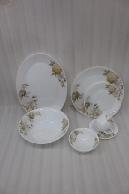 32-piece white ceramic dinnerware set featuring elegant yellow and white floral rose prints displayed on a marble countertop
