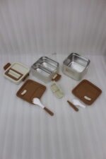 Cream and brown 2-in-1 double-layer portable lunch box with handle sitting on a kitchen counter
