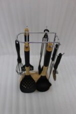 8 piece black silicone kitchen utensil set with wooden handles hanging on a chrome stand