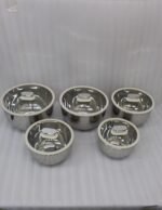 10 piece stainless steel mixing bowl set with clear glass lids sitting on a marble kitchen countertop