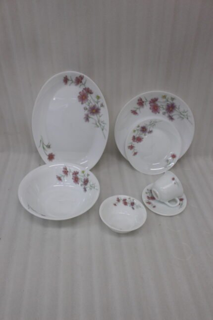 32-piece white printed dinner set with pink floral blossom design displayed on a white marble countertop