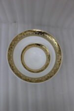 32-piece white porcelain dinner set with embossed gold trim including plates, bowls, cups, and a serving platter
