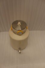 Off-white 7-liter insulated water cooler dispenser with spigot tap and stainless steel lid on a kitchen counter