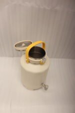 Off-white 7-liter insulated water cooler dispenser with spigot tap and stainless steel lid on a kitchen counter