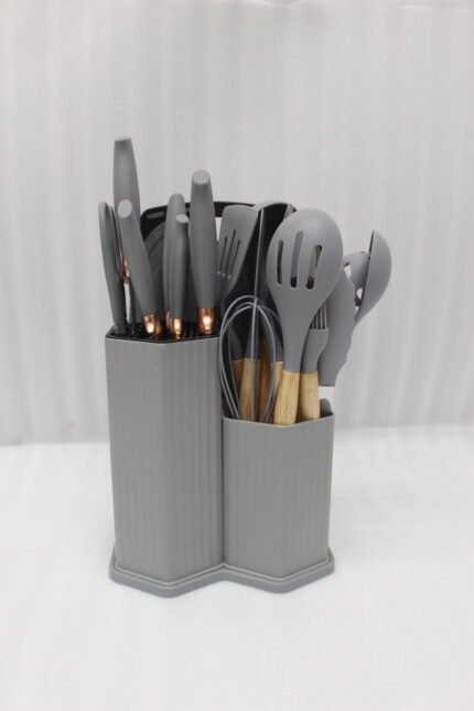 Grey 19-piece silicone kitchen utensil and knife set with wooden handles in a matching grey dual-compartment storage block.