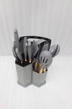 Grey 19-piece silicone kitchen utensil and knife set with wooden handles in a matching grey dual-compartment storage block.