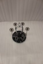 Modern silver chrome glass stand with crystal top finial holding six inverted glasses on a kitchen countertop.
