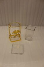 Luxury gold frame spoon stand with fluted clear acrylic container featuring a gold ginkgo leaf emblem on a marble countertop.