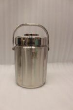 Polished insulated stainless steel lunch box container with a metal carrying handle on a kitchen countertop