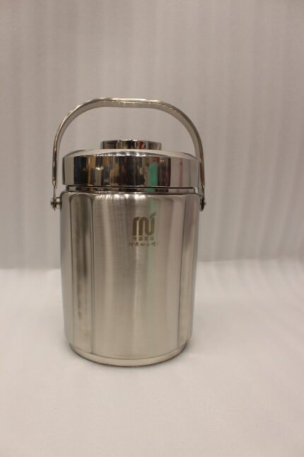 Polished insulated stainless steel lunch box container with a metal carrying handle on a kitchen countertop