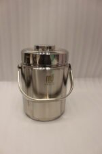 Polished insulated stainless steel lunch box container with a metal carrying handle on a kitchen countertop