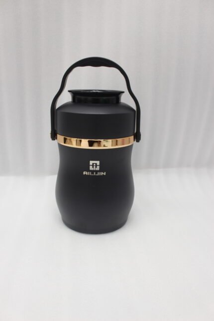 Matte black portable insulated lunch box jar with gold trim accent and black top handle on a kitchen counter