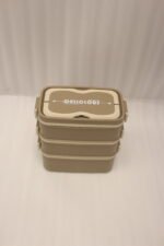 3-in-1 multi-tier beige and brown lunch box stacked on a kitchen countertop