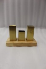 Modern brushed gold stainless steel salt and pepper shaker set with toothpick holder in a wooden base on a kitchen counter