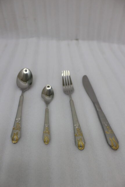 24-piece stainless steel cutlery set featuring gold "Love" engravings on handles, including rice spoon, sweet spoon, fork, and knife on a gray napkin.