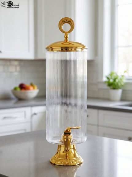3.5 liter ribbed glass beverage dispenser with polished gold base, lid, and spigot on a kitchen counter