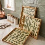 Set of wooden serving trays with printed bamboo stalk patterns resting on a kitchen countertop.