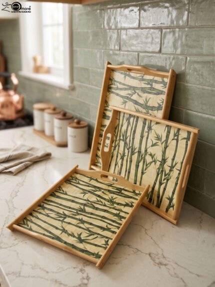 Set of wooden serving trays with printed bamboo stalk patterns resting on a kitchen countertop.