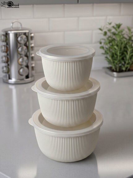 Stacked 3-piece white fluted food storage containers with clear airtight lids on a kitchen counter