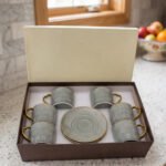 6-piece seafoam green ceramic tea cups with gold handles and matching saucers in a gift box