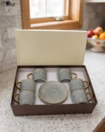 6-piece seafoam green ceramic tea cups with gold handles and matching saucers in a gift box