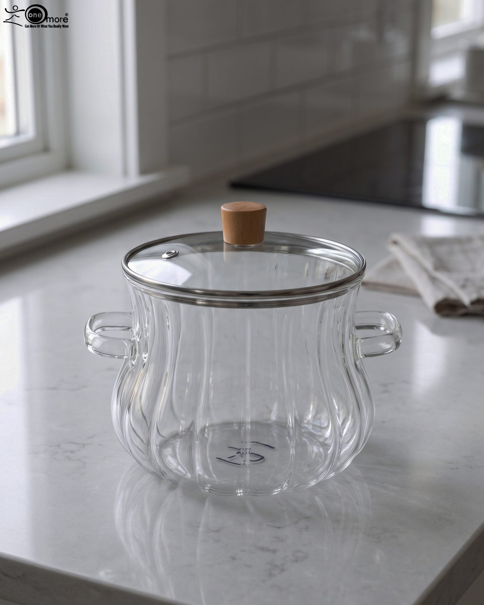 1 Clear ribbed glass cooking pot with wooden knob lid sitting on a white kitchen countertop