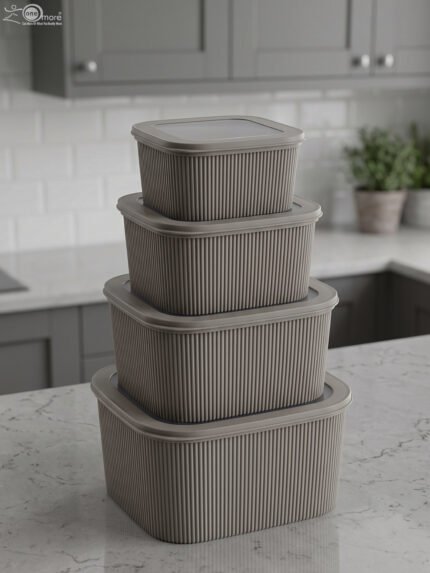Stacked 4-piece ribbed grey plastic storage box set with fitted lids on a marble kitchen countertop.