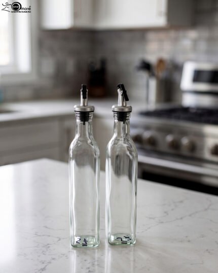 2 Pcs transparent glass oil dispenser bottles with stainless steel leak-proof pour spouts set on a marble kitchen counter