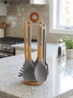 7 piece silicone cooking utensil set with wooden handles on a rotating stand