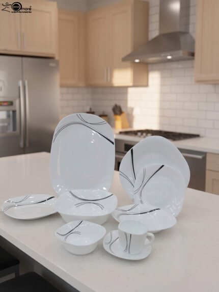 White opal glass dinner set with minimalist black linear wave design displayed on a kitchen island