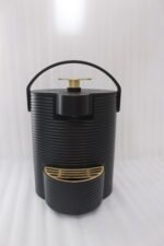 Modern ribbed matte black 2-liter hot water dispenser with gold top button, carrying handle, and gold drip tray on a kitchen countertop.