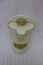 Modern cream-colored 2L ribbed water dispenser pitcher with gold accents and carrying handle on a marble kitchen countertop.